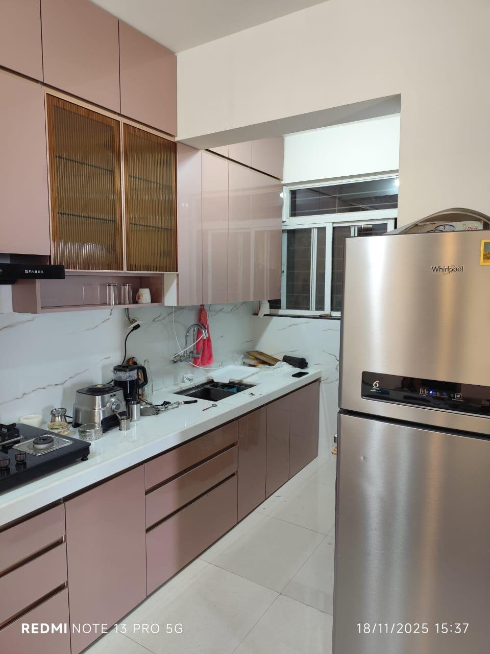 Parallel modular kitchen in dusty rose with fluted glass shutters