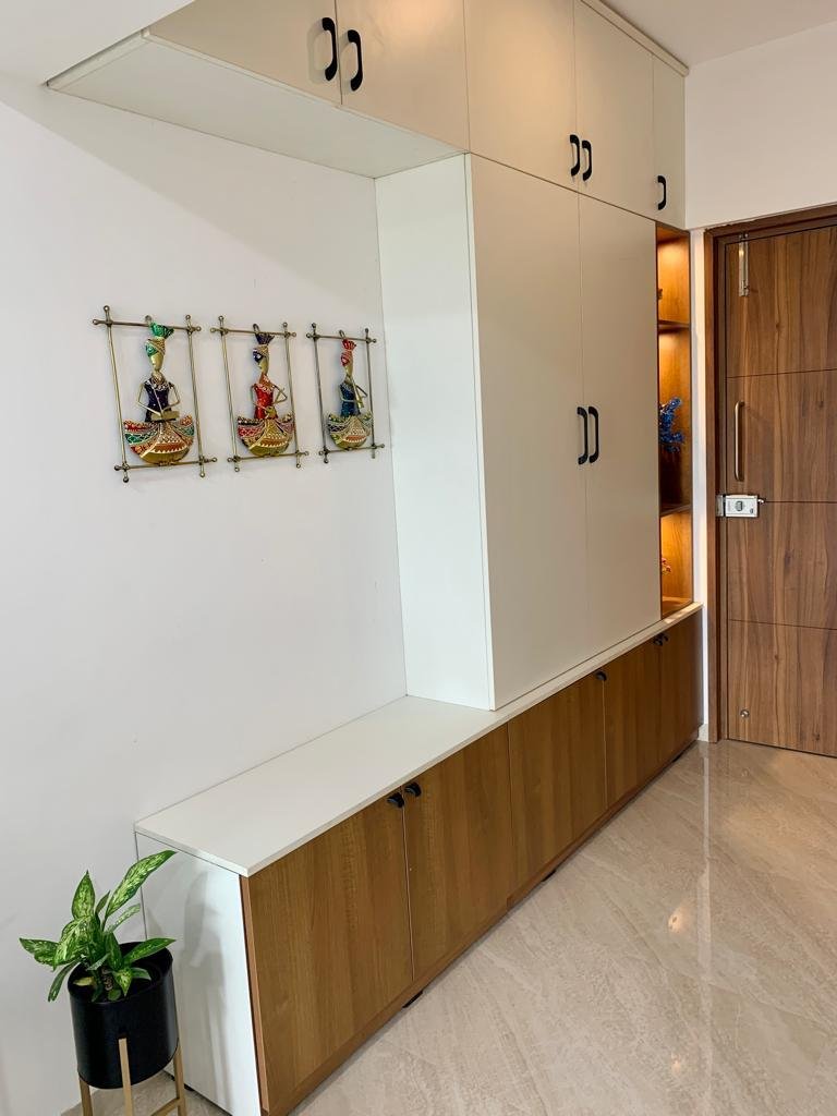 Tall cream wardrobe with a low entryway bench unit